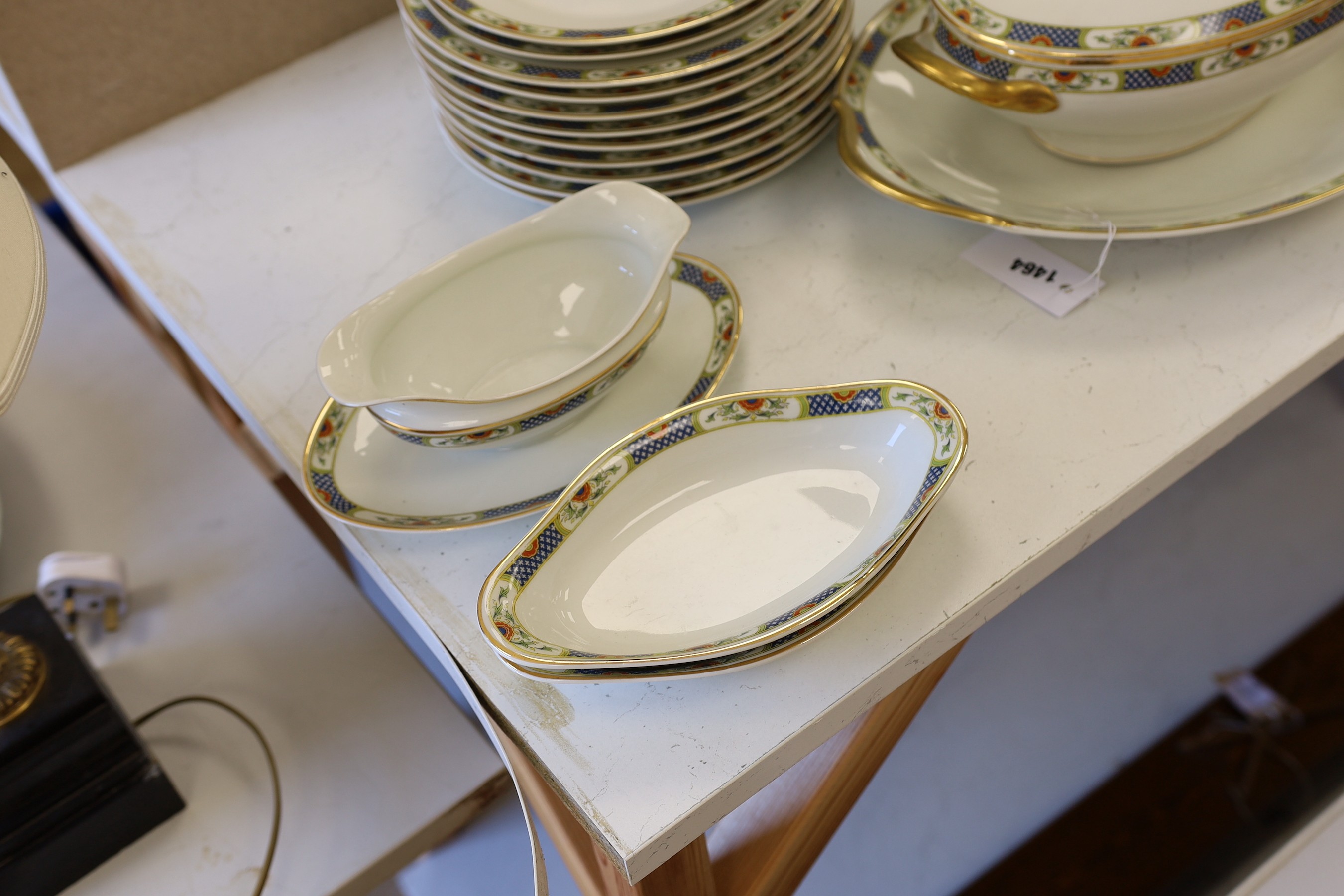 A Limoges gilt and floral decorated dinner service